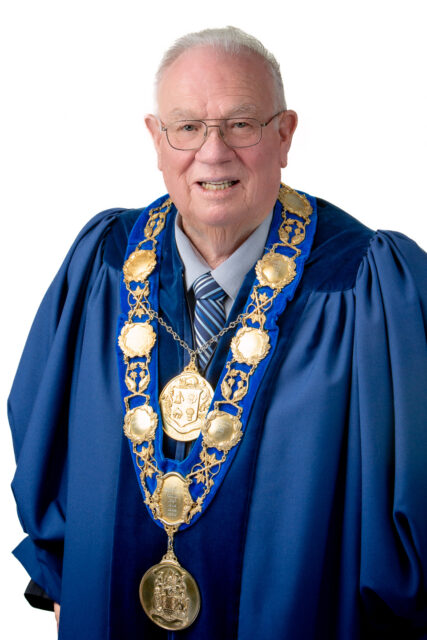 Mayor Jim Harrison adorning the robe and chain of the Office of the Mayor for the City of Quinte West.